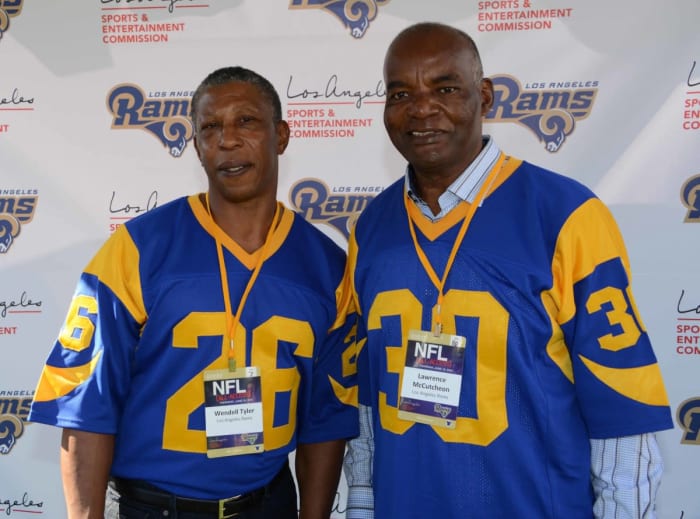Former Rams running backs Wendell Tyler (26) and Lawrence McCutcheon (30) pose at an NFL All-Access event at the Los Angeles Memorial Coliseum in 2016.